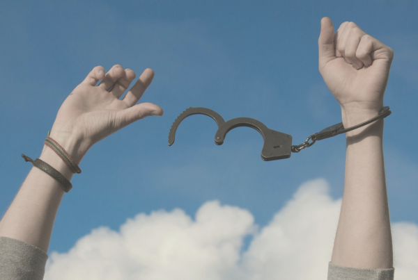 Image of hands breaking free from the handcuffs, symbolizing emotional trauma.