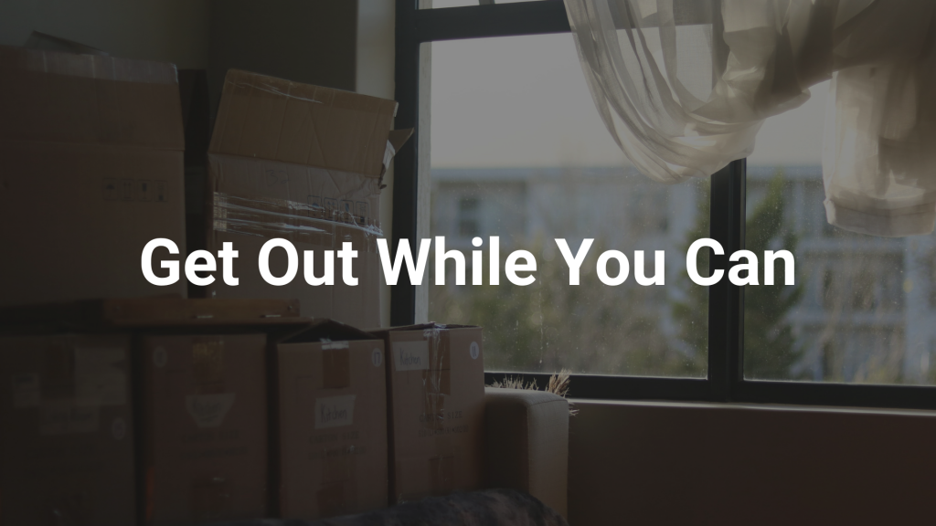 Image of boxes full of personal belongings with "Get Out While You Can" text overlayed, suggesting a person should leave a situation of emotional abuse.